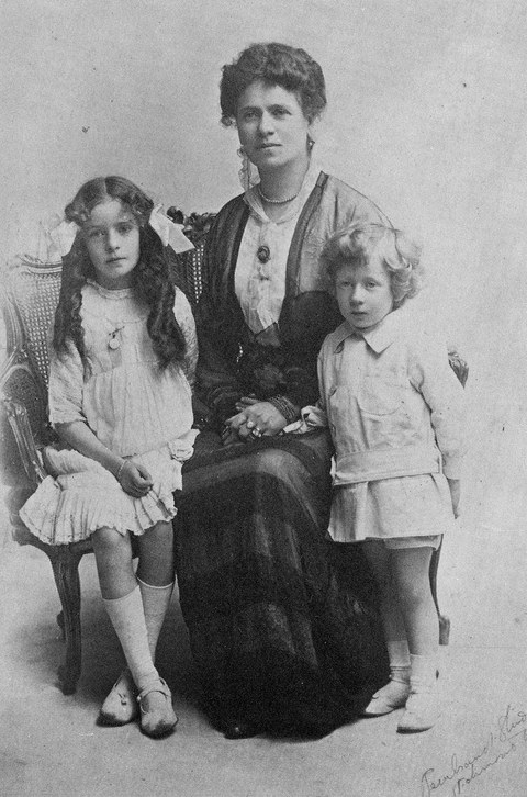 Photo with Sir Patrick's sister Lena seated to the left of his mother whilst he stands to the right
    