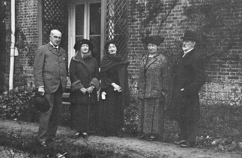 Group Photo standing in front of a house
    